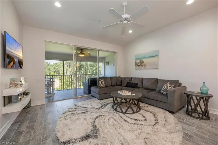 Living area featuring wood finished floors, baseboards, and recessed lighting