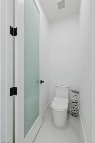 Bathroom with toilet and baseboards