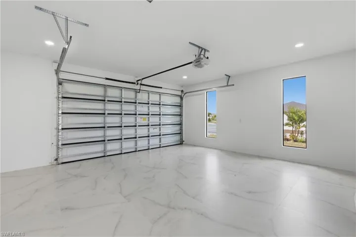 Garage featuring recessed lighting and a garage door opener