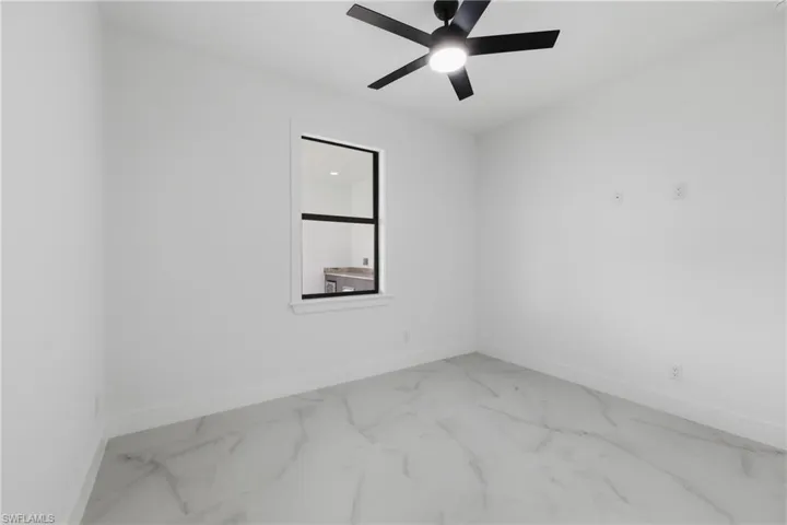 Empty room with baseboards and ceiling fan