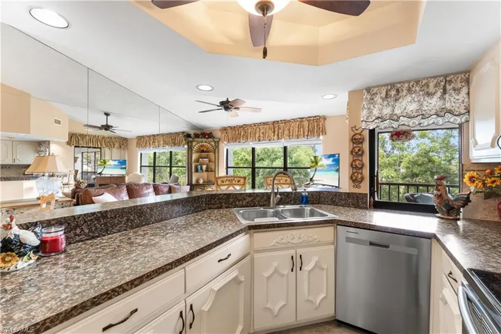 Your kitchen opens up to your main living area AND it has a great pass thru window to your large lanai. What a bonus for entertaining! Tray ceiling.