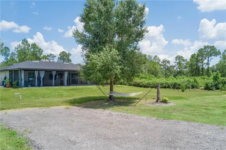View of community with a yard and a sunroom