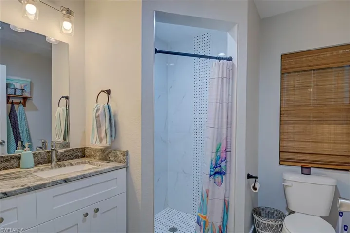 Full bathroom featuring vanity and a stall shower