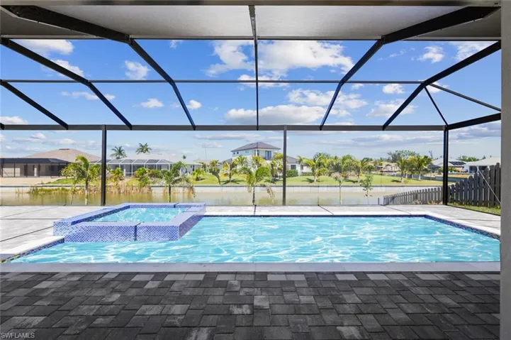 View of swimming pool featuring a patio, a lanai, and a pool with connected hot tub