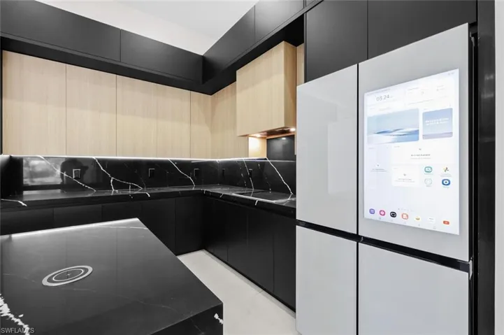 Kitchen with freestanding refrigerator, modern cabinets, and dark cabinetry