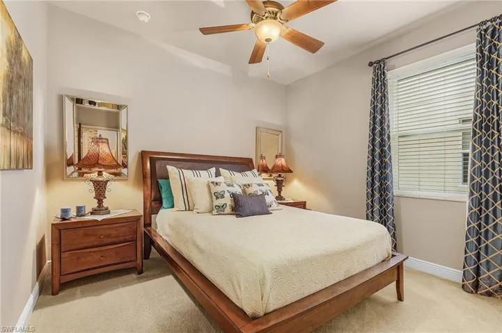 Carpeted bedroom with ceiling fan