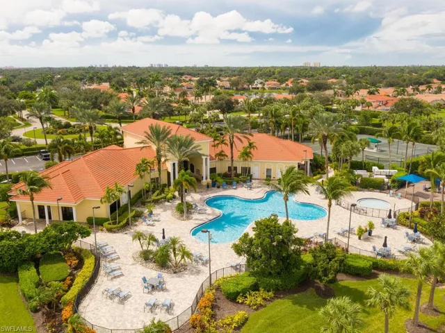 Aerial view of the community clubhouse, showcasing top-tier amenities, including tennis and pickleball courts, a fitness center, and a resort-style pool and spa.