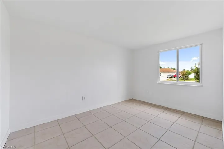 Unfurnished room with light tile patterned floors