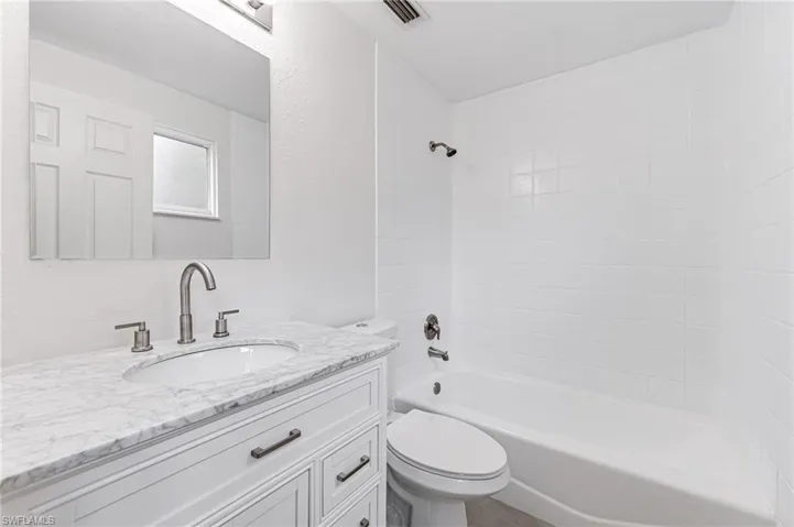 Full bathroom with shower / bathtub combination, toilet, and vanity
