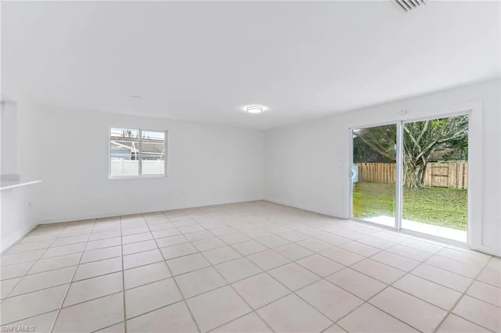 Spare room featuring a wealth of natural light and light tile patterned flooring