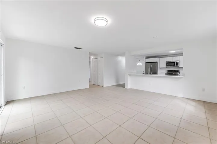 Unfurnished living room featuring light tile patterned flooring