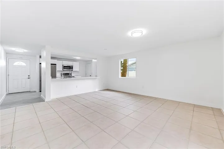 Unfurnished living room featuring light tile patterned flooring