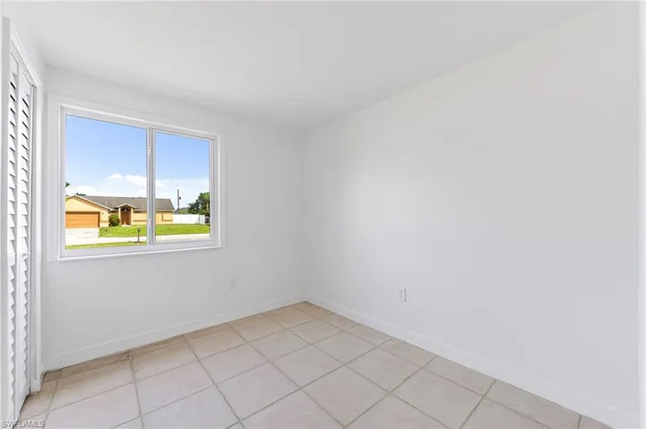 Spare room featuring light tile patterned floors