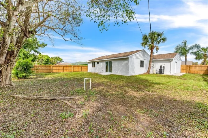 Back of house with a lawn