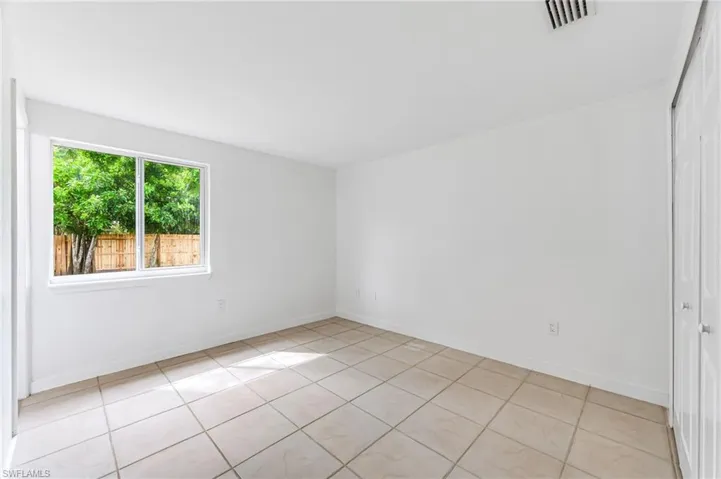 Empty room with light tile patterned floors