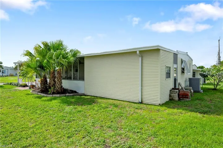 View of home's exterior with a lawn and central air condition unit