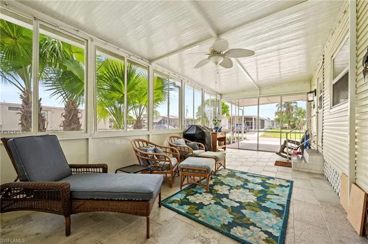 Sunroom with ceiling fan and outdoor lounge area