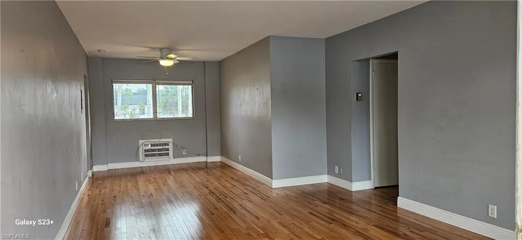 Spare room featuring wood-type flooring and a ceiling fan