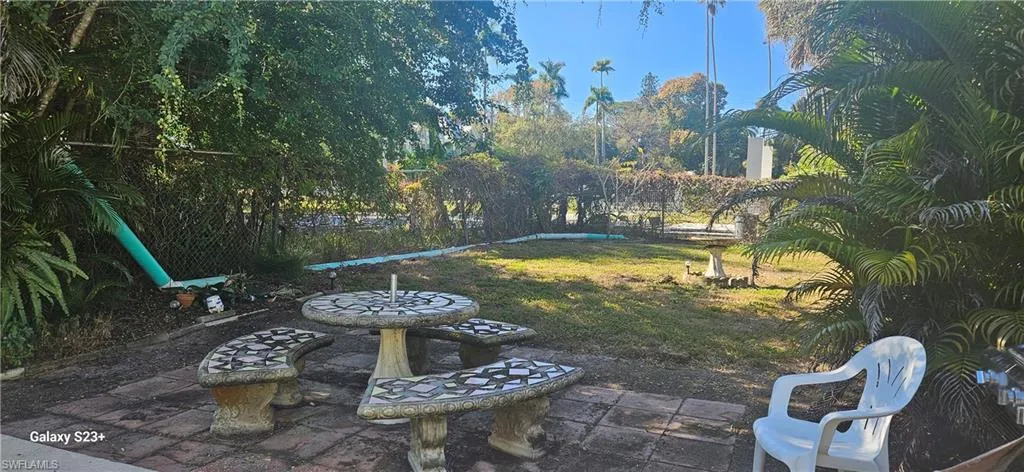 View of grassy yard featuring a patio area