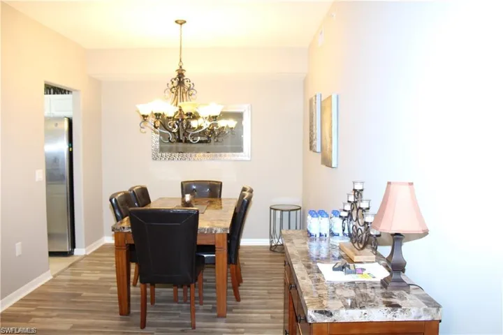 Dining space with wood-type flooring and a notable chandelier
