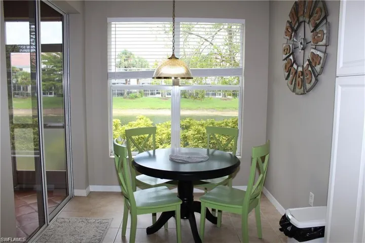 Tiled dining room featuring a wealth of natural light