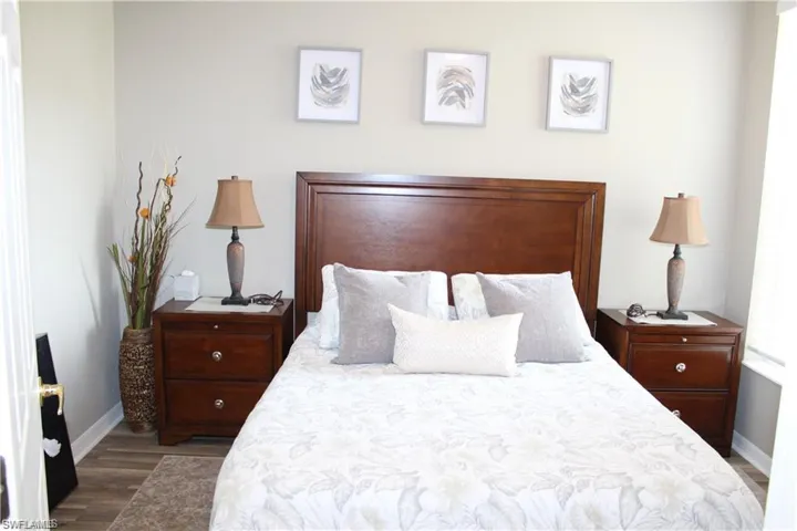 Bedroom with dark hardwood / wood-style floors