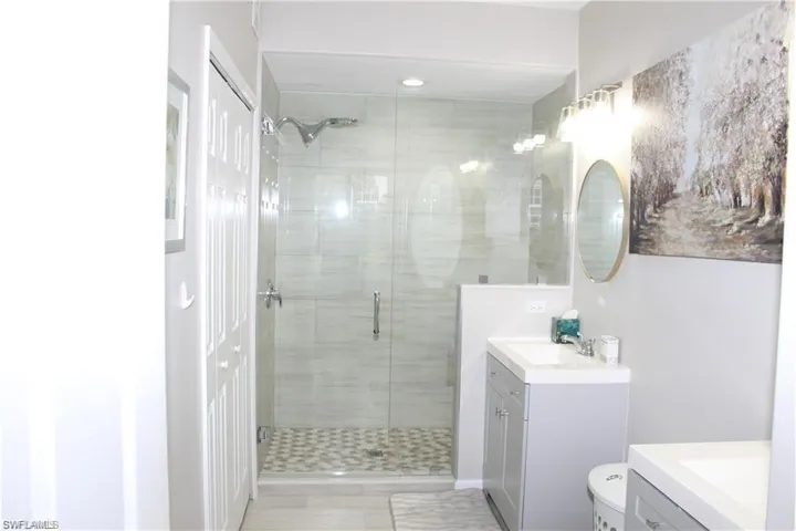 Bathroom featuring walk in shower and vanity