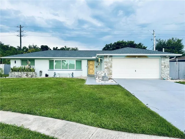 Single-story residence featuring a white exterior and a dark shingle roof