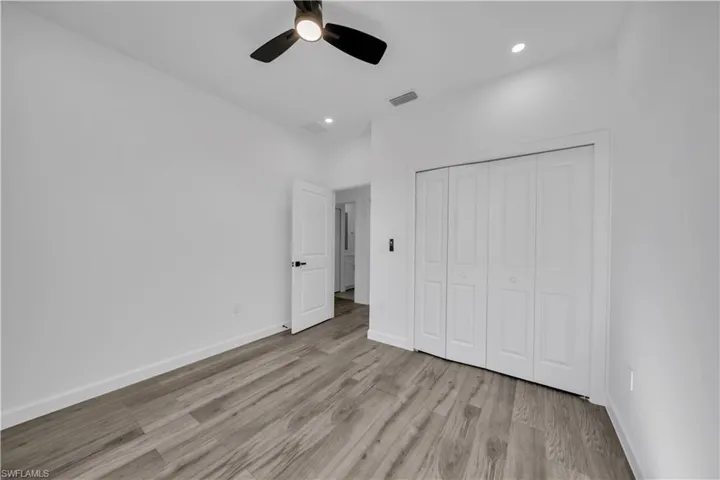 Unfurnished bedroom featuring a closet, a ceiling fan, recessed lighting, and light wood finished floors
