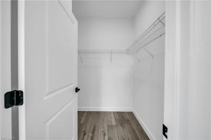 Walk in closet featuring light wood-style flooring