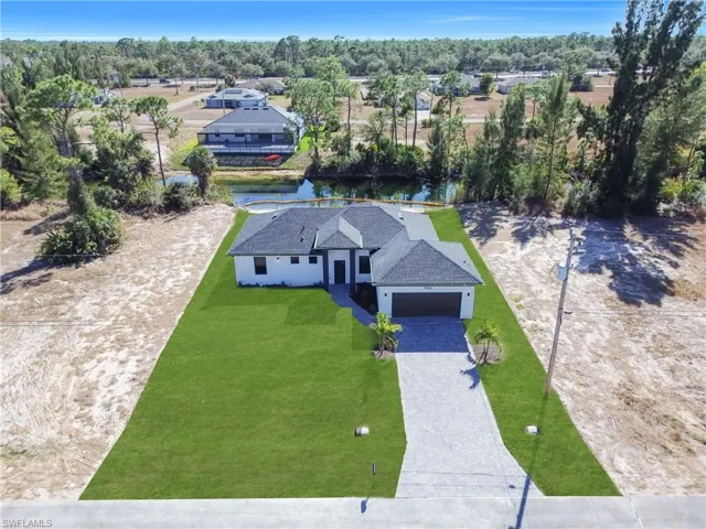 Aerial view of a nearby body of water and a tree filled landscape