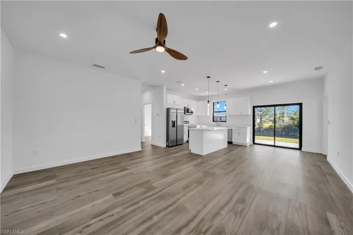 Unfurnished living room featuring a ceiling fan, recessed lighting, and light wood finished floors