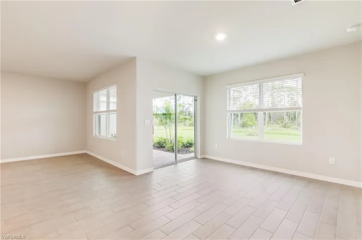Unfurnished living room featuring healthy amount of natural light, light wood-style flooring, and recessed lighting