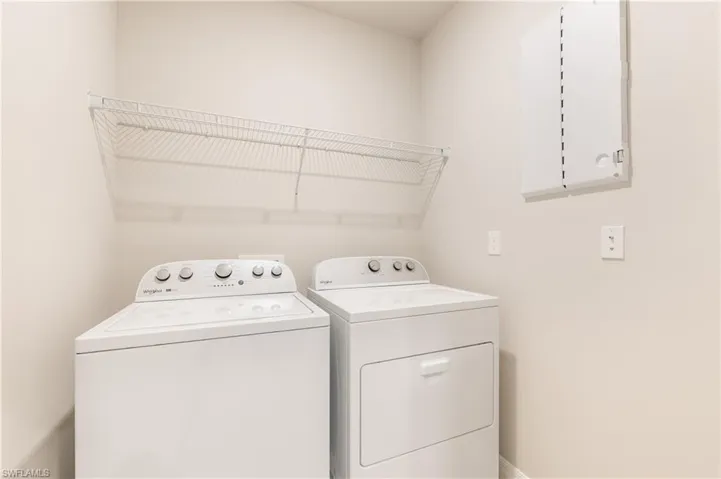Laundry area with independent washer and dryer and baseboards