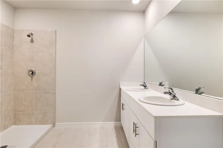 Bathroom featuring a sink and a shower stall