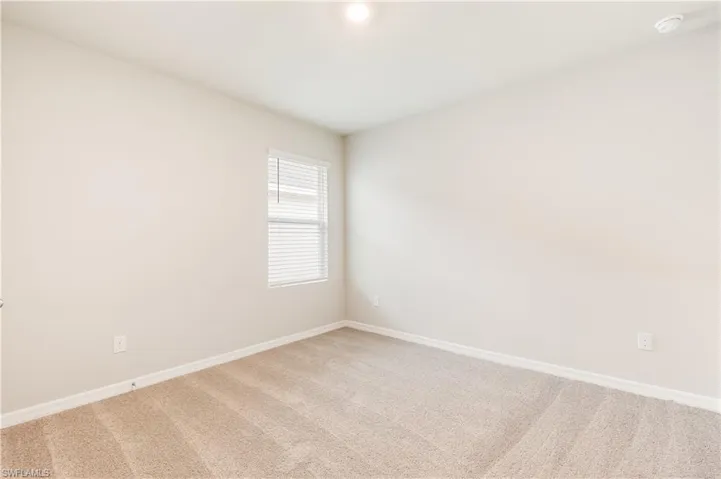 Unfurnished room featuring carpet floors and baseboards