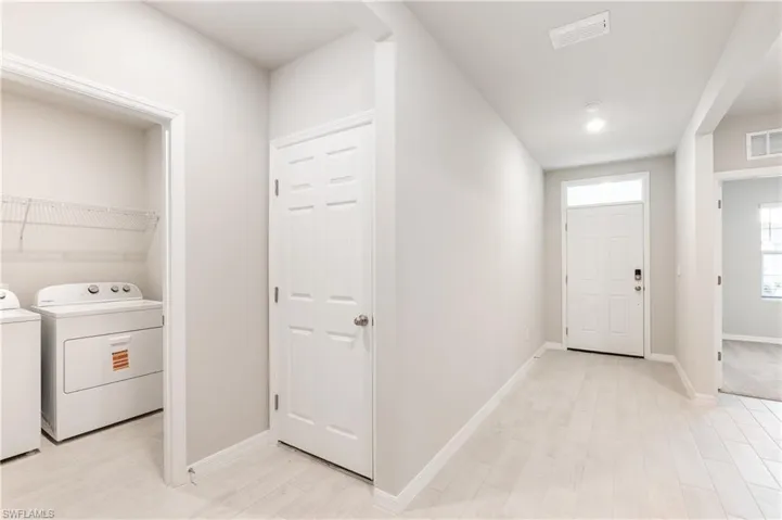 Entryway featuring light wood-type flooring and washer and clothes dryer