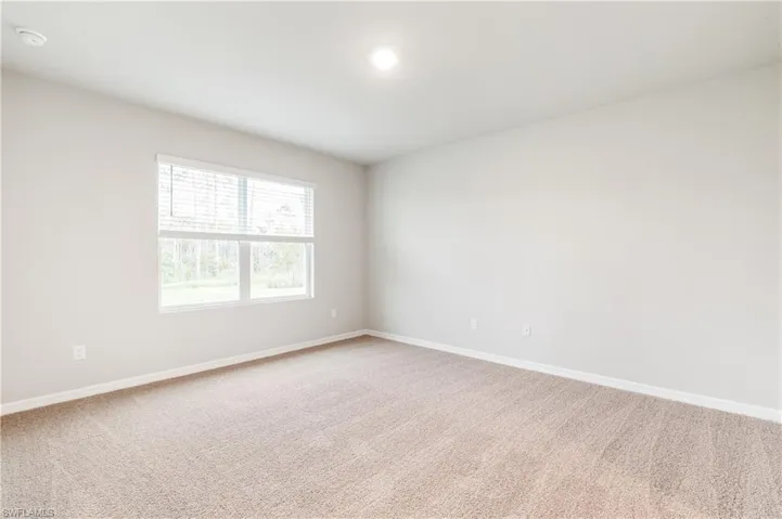 Spare room featuring light carpet and recessed lighting