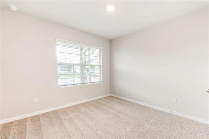 Empty room with carpet and baseboards