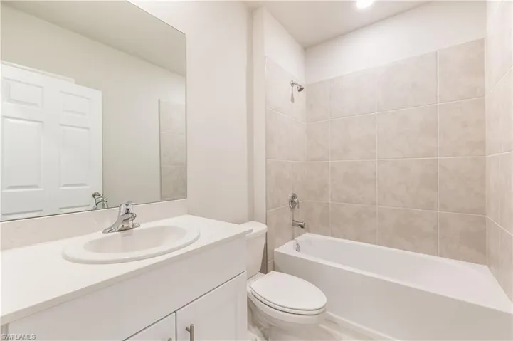 Bathroom with shower / bathtub combination and vanity
