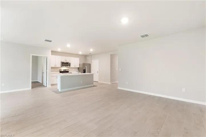 Unfurnished living room with recessed lighting and light wood-type flooring