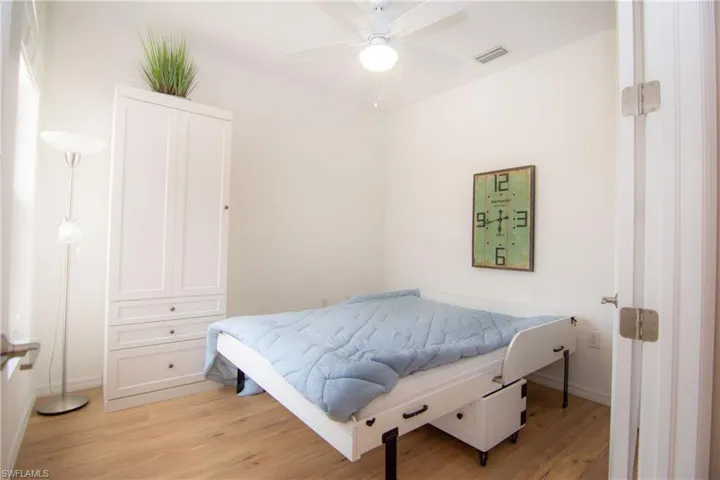 Open the French Doors to the Den/Bedroom and enjoy a flexible space with a hutch/desk and Murphy bed set up.  Features LVP floors, a ceiling fan and a full sized closet.