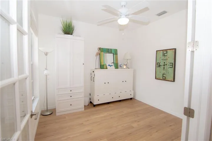 Open the French Doors to the Den/Bedroom and enjoy a flexible space with a hutch/desk and Murphy bed set up.  Features LVP floors, a ceiling fan and a full sized closet.