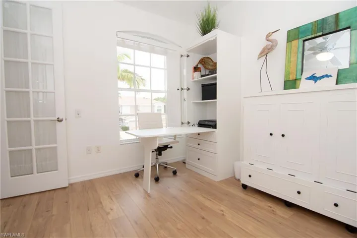 Open the French Doors to the Den/Bedroom and enjoy a flexible space with a hutch/desk and Murphy bed set up.  Features LVP floors, a ceiling fan and a full sized closet.