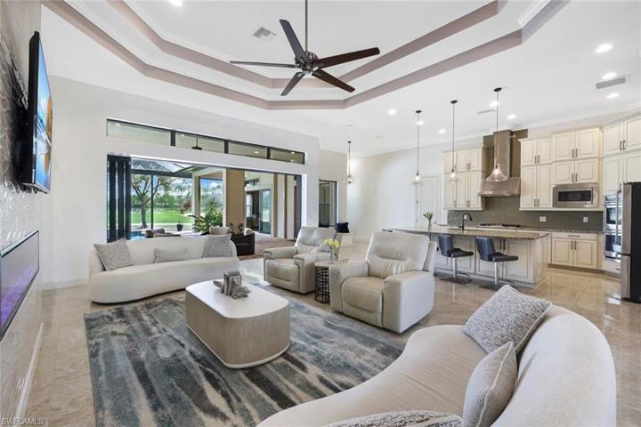 Highly desirable, open floor plan, with soaring tray ceilings, crown molding and an amazing view of the outdoor living space and golf course beyond.