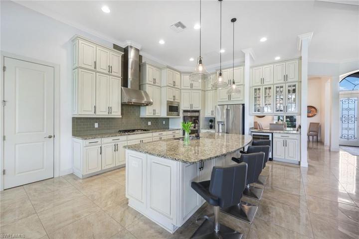 This kitchen is a chef's dream! Note the natural GAS stove, DOUBLE wall ovens, built-in wine cooler, tons of cabinet space (featuring upper cabinets), and even a walk-in pantry!