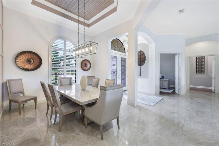 Formal dining room is the perfect spot for holiday celebrations. Note the detailed decorative work on the wall as well as the tongue and groove wood ceiling.