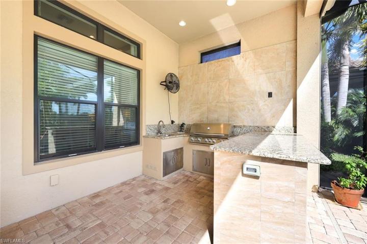 Ready to grill? This fully equipped outdoor kitchen boasts a natural gas grill, beverage refrigerator, outdoor sink, and additional storage space.