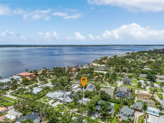 Aerial overview of property's location featuring a large body of water and nearby suburban area