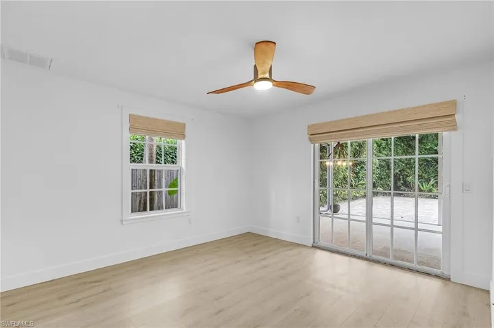 Bedoom with light wood-style flooring and ceiling fan